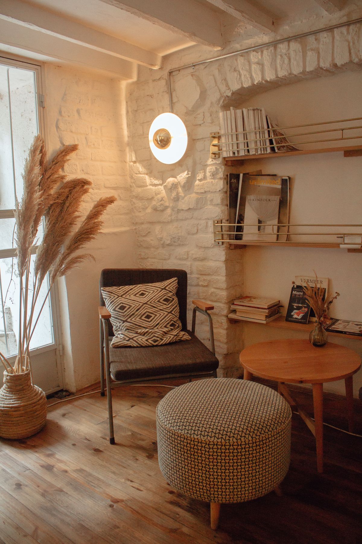 A warm reading corner with a chair, books, and soft light - the room nobody sees you in